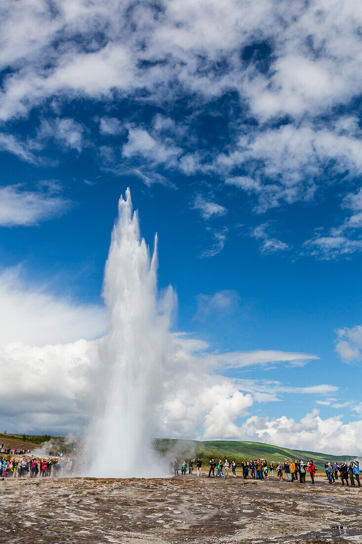 Tourists gather to watch Strokker geyser (geysir), an erupting spring at Haukadalur, Iceland, Polar Regions