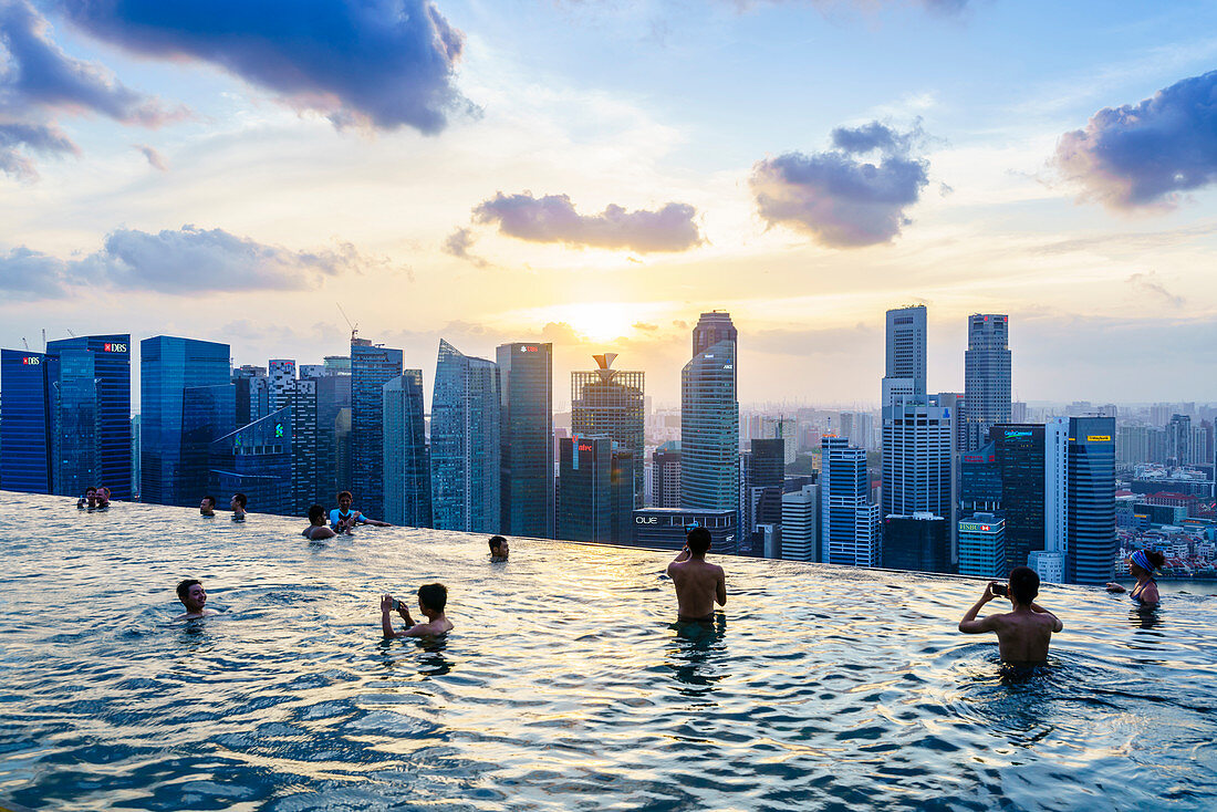 Infinity pool on the roof of the Marina Bay Sands Hotel with spectacular views over the Singapore skyline at sunset, Singapore, Southeast Asia, Asia