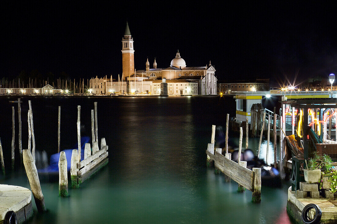 The island and church of San Georgio Maggiore at night with a boat dock in the foreground, Venice, UNESCO World Heritage Site, Veneto, Italy, Europe