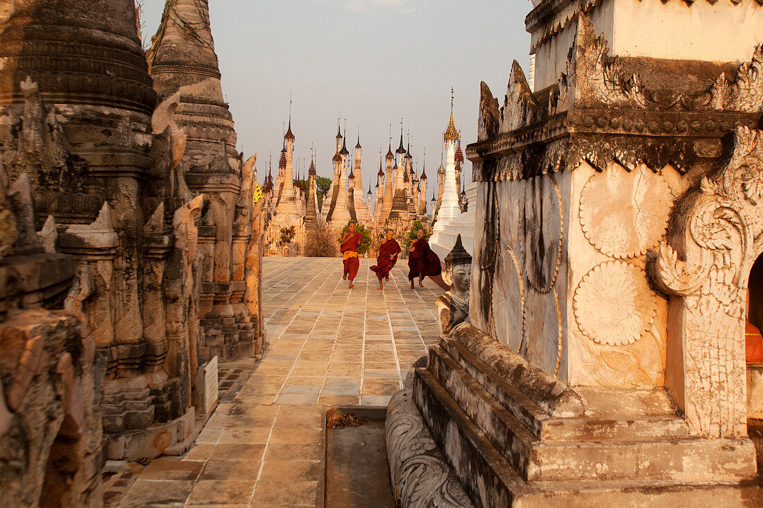 Young novices run through the pagodas, Kakku Pagoda Complex, Myanmar (Burma), Asia