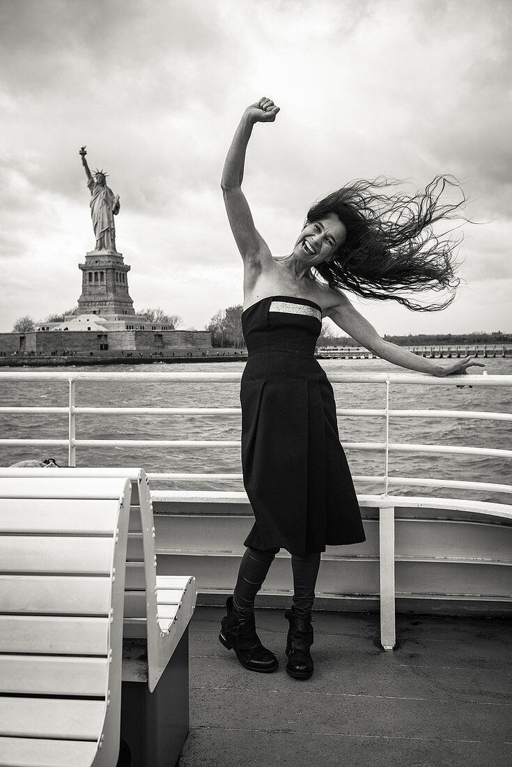 Woman in front of the Statue of liberty, New York City, New York, USA