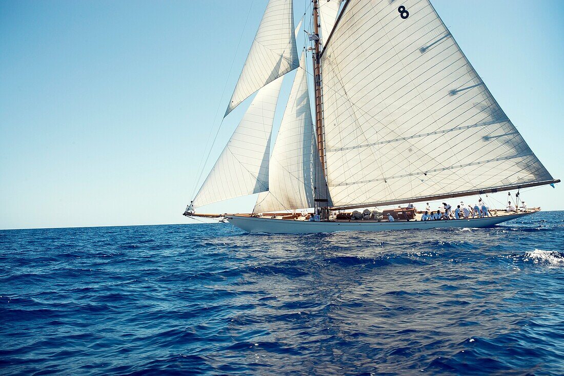 Vintage sailboat with many crewmembers on board sailing the Mediterranean sea Minorca, Balearic Islands
