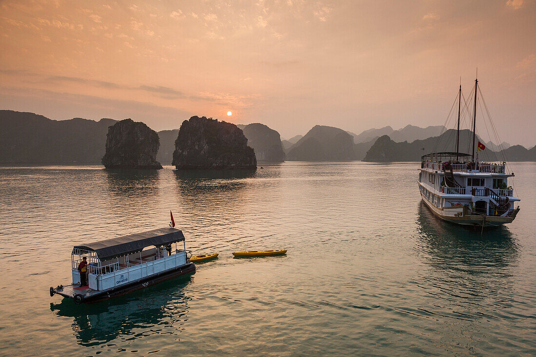 Vietnam, Halong Bay, tourist boats, dusk.