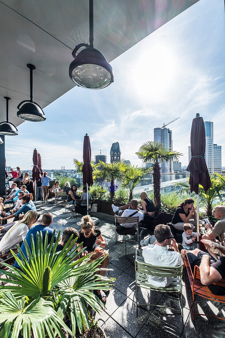 People on the terrace of the 25hours hotel and view to the Gedaechnis church, Berlin, Germany