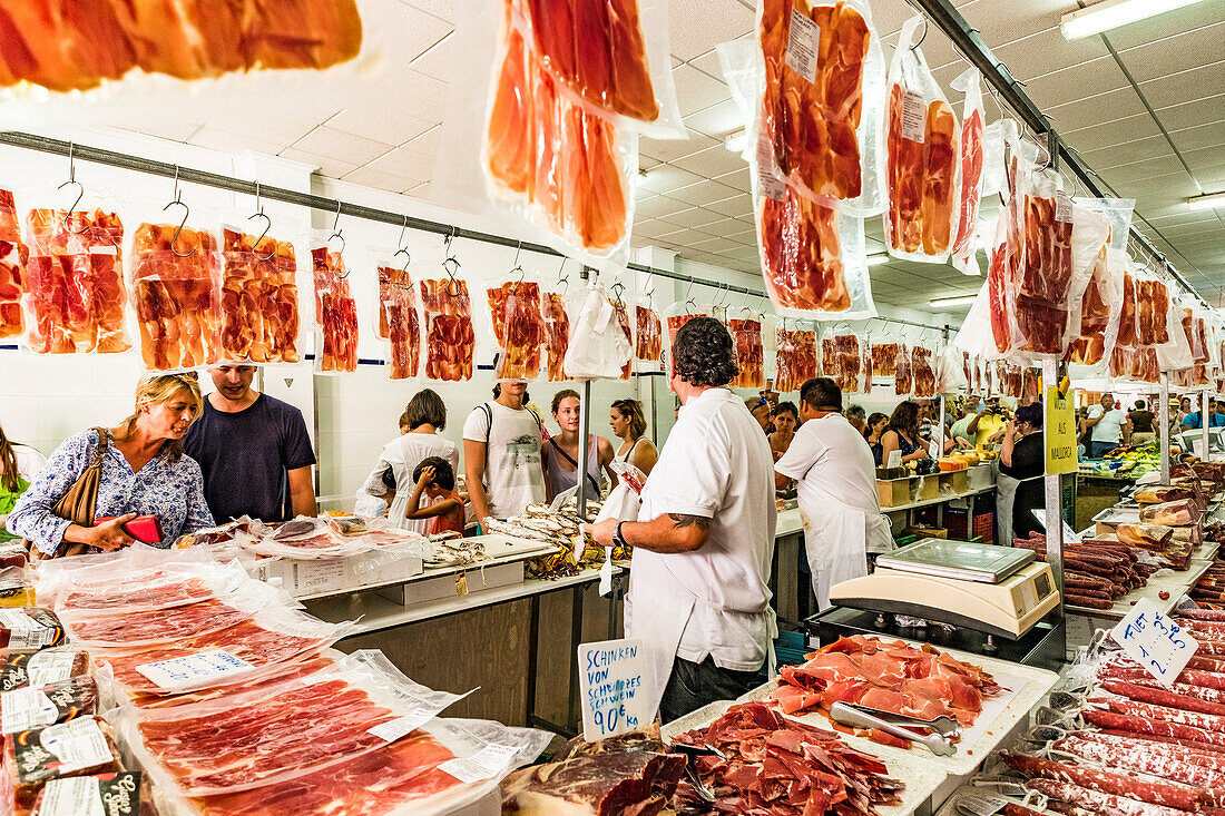 ham seller in the market hall in Arta, Mallorca, Balearic Islands, Spain