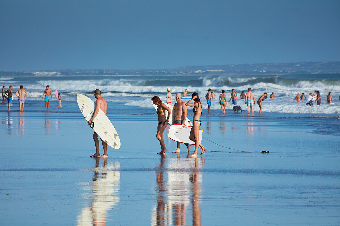 Surfers and bathers on the beach of Canggu, Bali, Indonesia