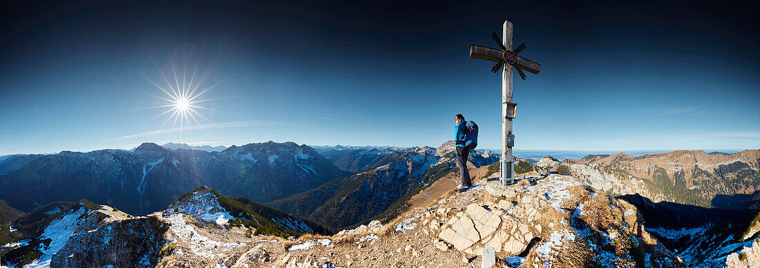 Hikers in the late Autumn at the summit of the Scheinbergspitze, Ammergauer Alps, Germany