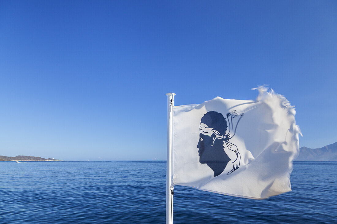 Corsican flag on ferry from Saint-Florent to Loto Beach, Corsica, Southern France, France, Southern Europe