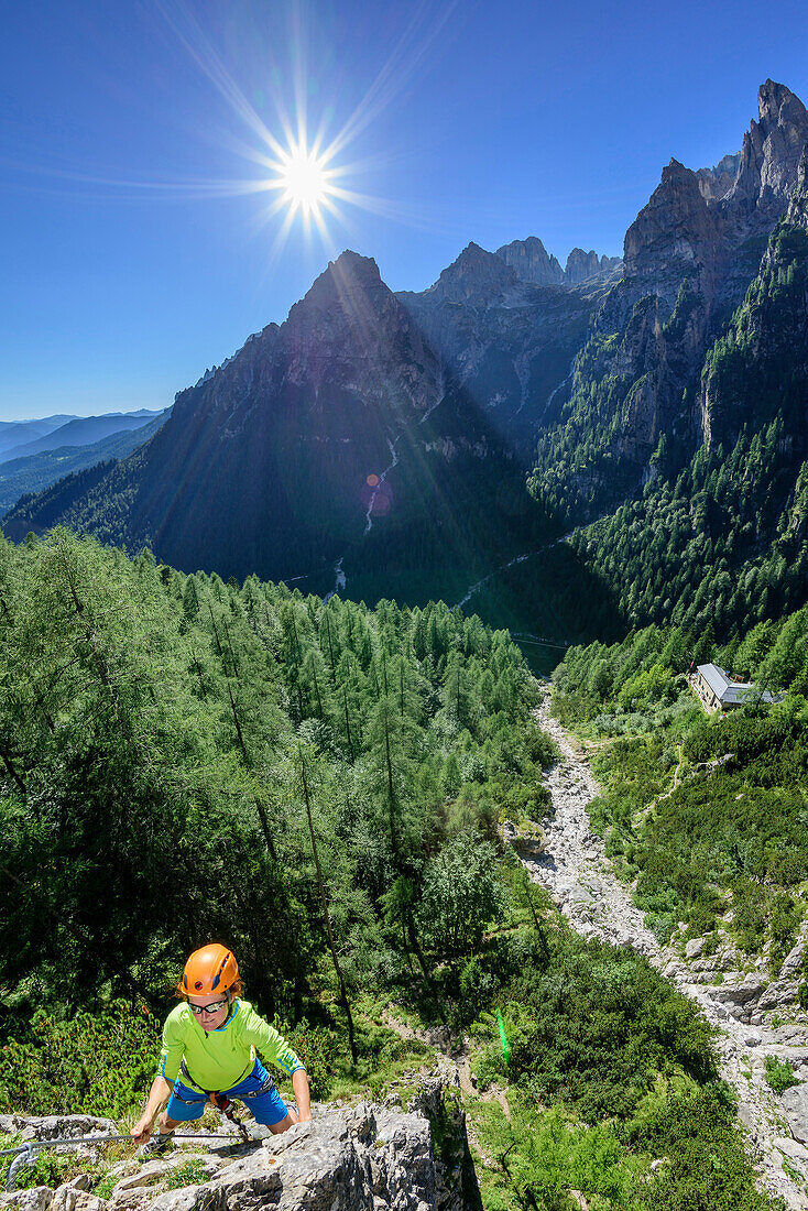 Woman climbing on fixed-rope route Canalone, Val Canali in background, Val Canali, Pala Group, Dolomites, UNESCO World Heritage Site Dolomites, Trentino, Italy