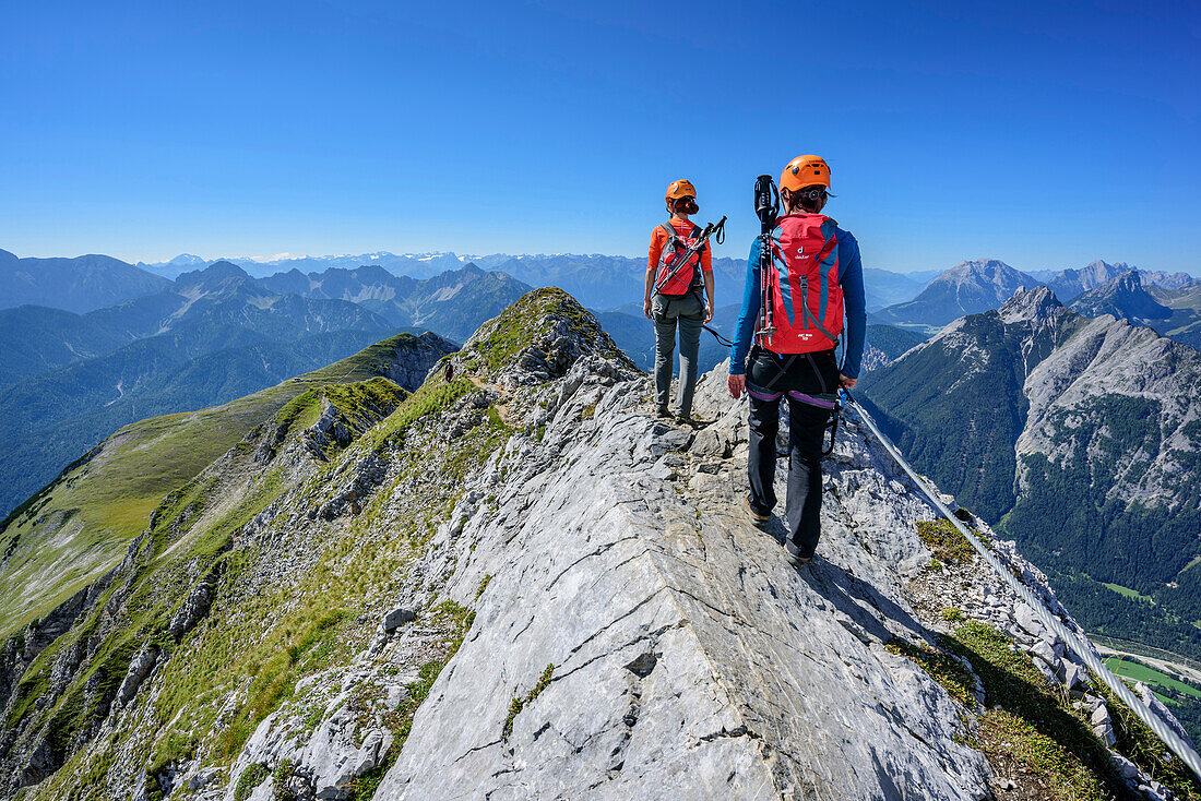 Two women climbing on fixed-rope route Mittenwalder Hoehenweg, fixed-rope route Mittenwalder Hoehenweg, Karwendel range, Upper Bavaria, Bavaria, Germany