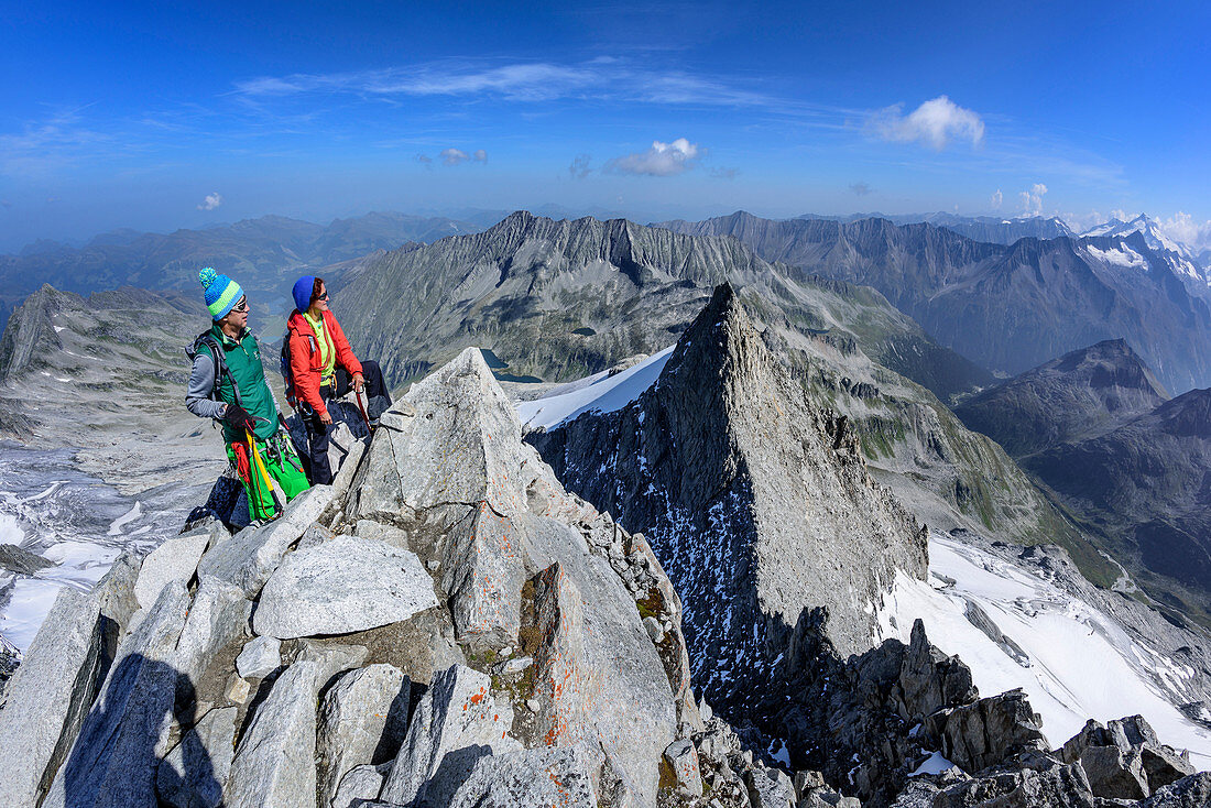 Man and woman standing at summit of Reichenspitze, Reichenspitze, Zillergrund, Reichenspitze group, Zillertal Alps, Tyrol, Austria
