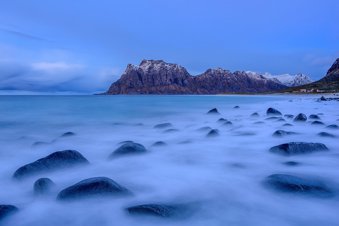 Rocks flooded by surf, mountains in background, Lofoten, Norland, Norway