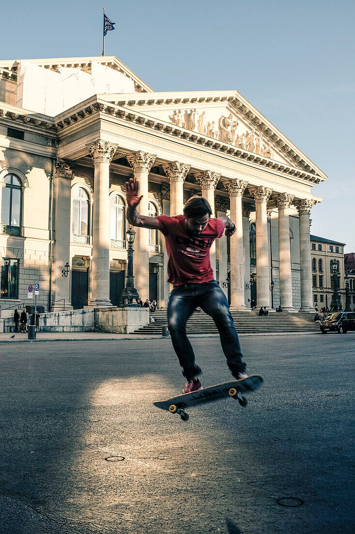 Skateboarder in front of the Residenz Theater in Munich, Bavaria, Germany