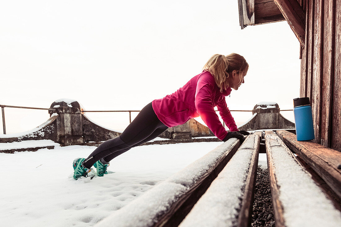 young woman stretching near Lake Starnberg, Bavaria, Germany.