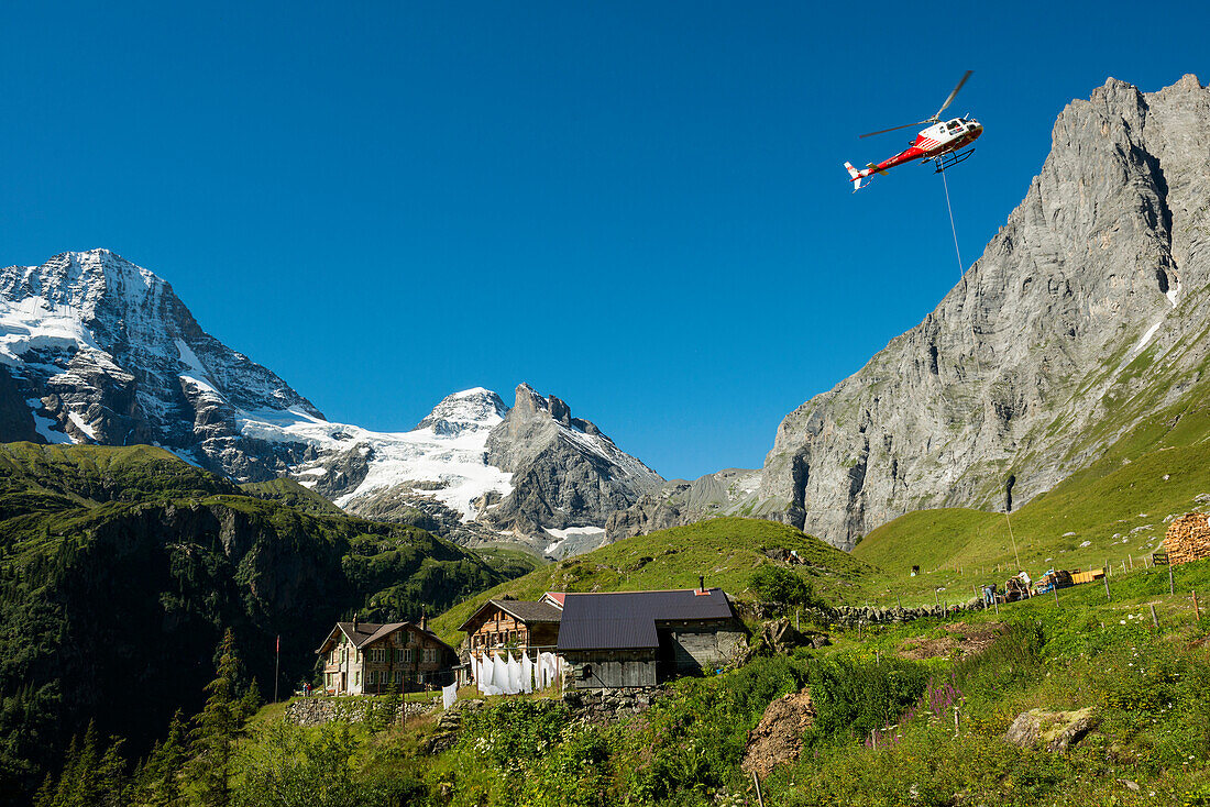Berggasthof Obersteinberg, mountain guesthouse, transport helicopter, Tschingelhorn behind with snow, Lauterbrunnen, Swiss Alps Jungfrau-Aletsch, Bernese Oberland, Canton of Bern, Switzerland