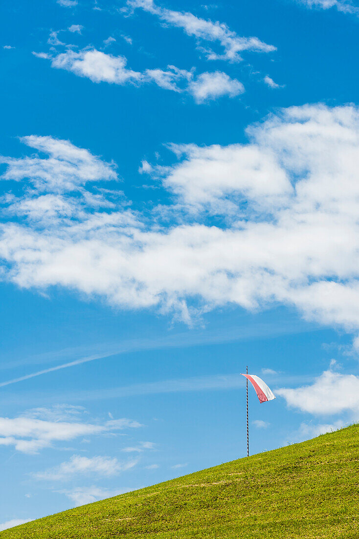 The South Tirol flag on a mountain slope, Radein, South Tyrol, Italy