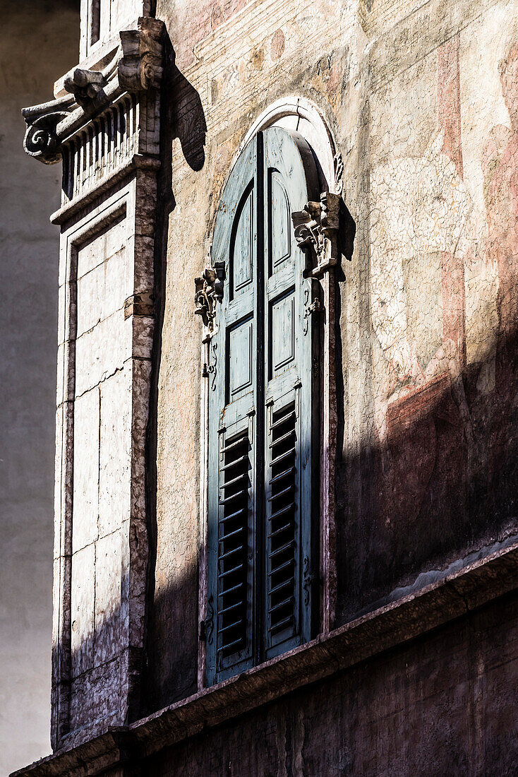 An old house with weather-beaten facade in the Old Town, Trento, Trentino, South Tyrol, Italy