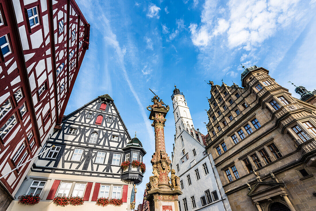 The house Jagstheimerhaus and the town hall with the market fountain at the town hall square, Rothenburg ob der Tauber, Bavaria, Germany