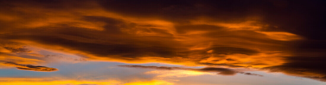 Panorama of colourful dramatic chinook arc cloud at sunset, Calgary, Alberta, Canada