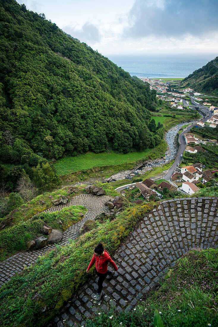 Young woman trekking in Faial da Terra, Sao Miguel, Azores, Portugal