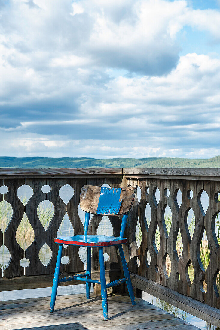 old chair on the veranda at the border of lake Siljan, Solleron, Dalarna, Sweden