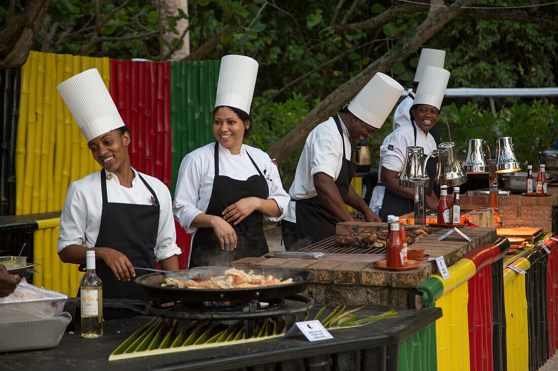 Cheerful chefs during Friday evening Beach BBQ at Sunrise Beach of Half Moon Resort Rose Hall, near Montego Bay, Saint James, Jamaica