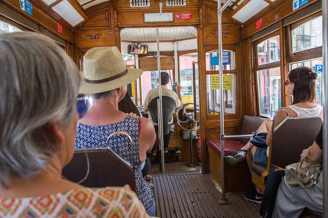 interior of tram, passengers, Lisbon, tourist attraction, Portugal
