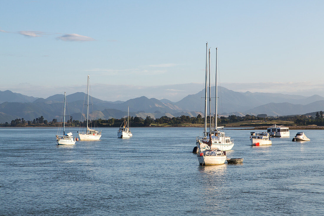 Mapua, harbour, sheltered bay, anchored boats, mountains on horizon, Tasman District, South Island, New Zealand