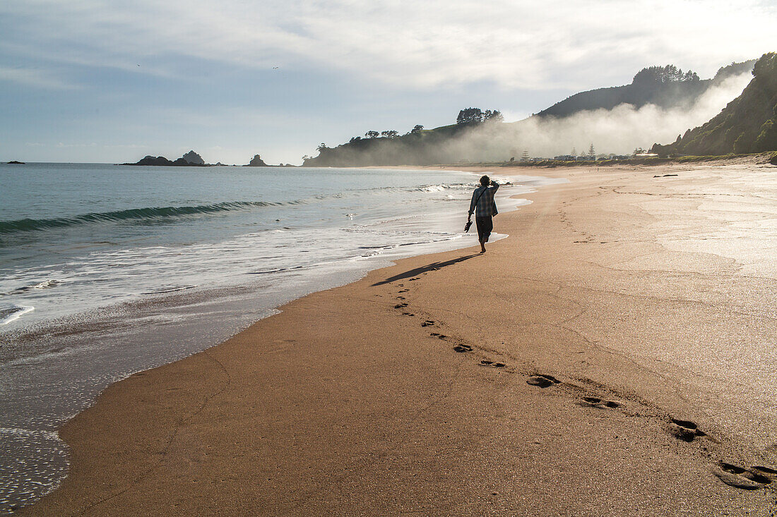 morning sea mist, footprints in sand on beach, person, pristine beach, Tauranga Bay, Northland, North Island, New Zealand