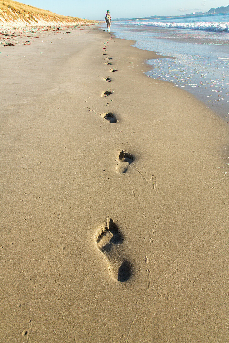 barefeet, footprints in golden sand on beach, pristine beach, water, high format, sea foam, nobody, Waipu, North Island, New Zealand