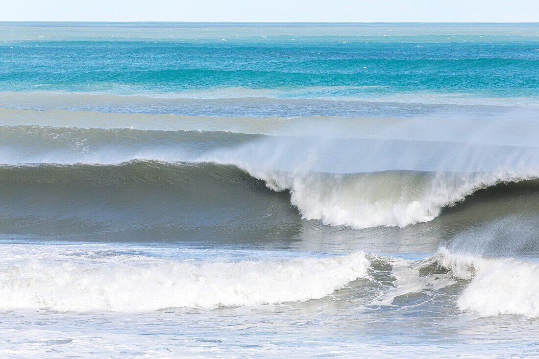 Surf, spray from crest of wave, water, ocean, churned up sandy water, South Island, New Zealand