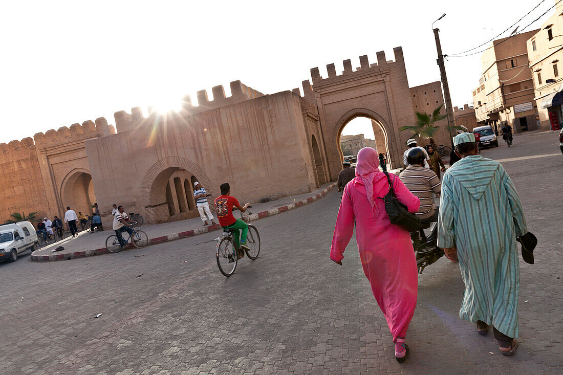 Couple approaching old city wall and ramparts, Taroudant, Morocco