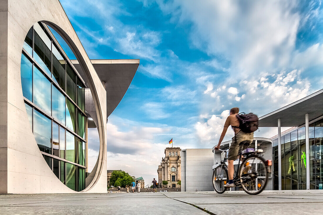 Cyclist on the promenade in the Government Quarters, Marie-Elisabeth-Lueders-Haus, Paul-Loebe-Haus und Reichstag, Berlin, Germany