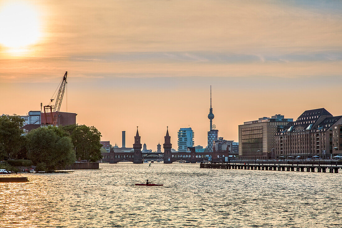 Sunset over the River Spree, view toward Oberbaum bridge and TV tower, Kreuzberg, Berlin, Germany