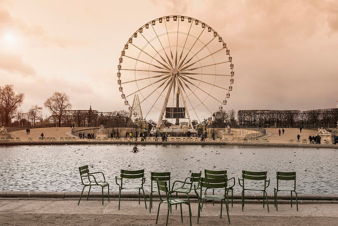 Tourists walking near ferris wheel, Paris, Ile-de-France, France