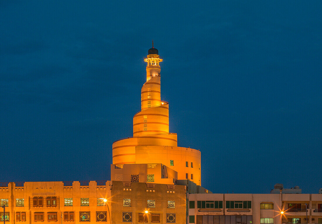 Islamic Cultural Center spire illuminated at night, Doha, Qatar