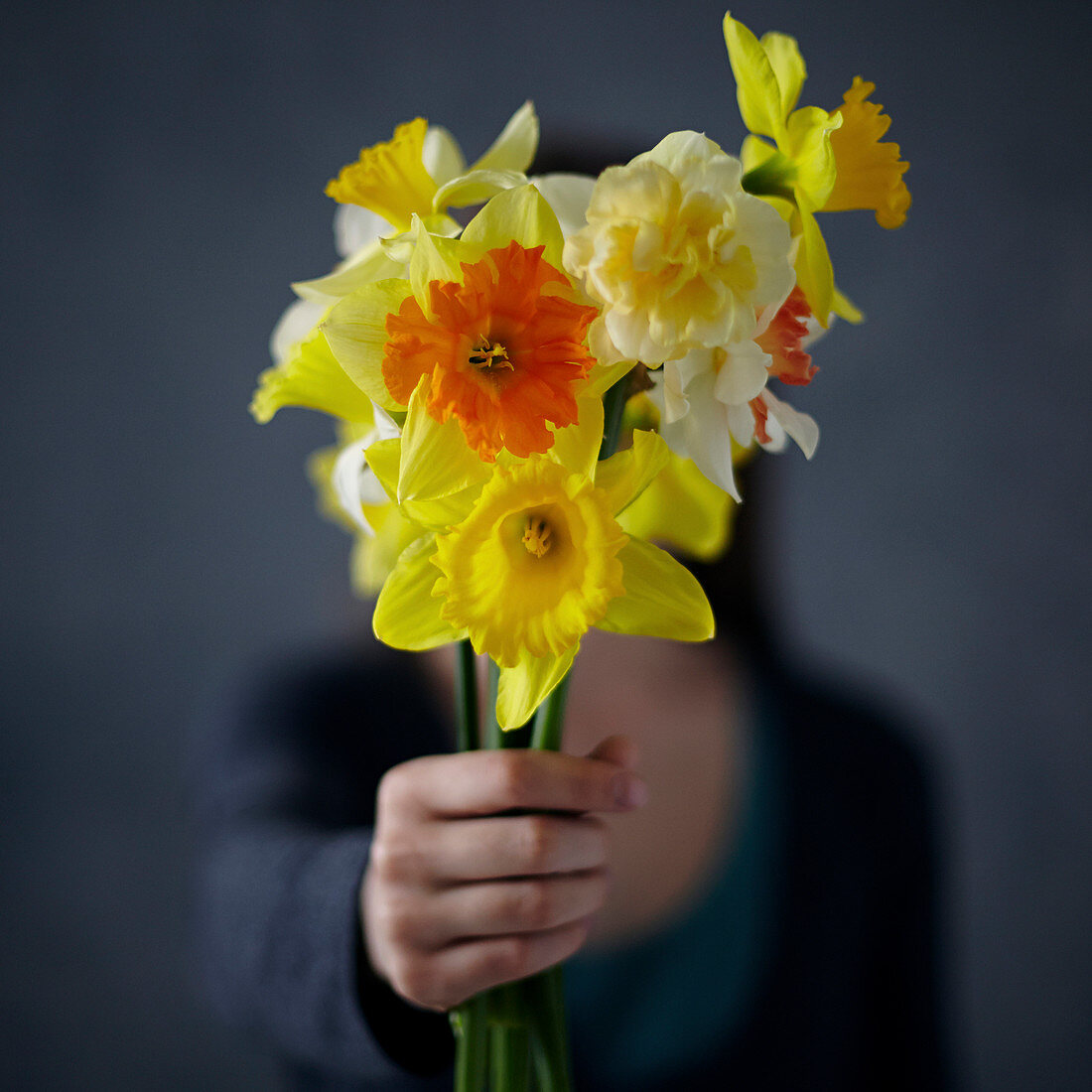 Caucasian girl showing bouquet of flowers