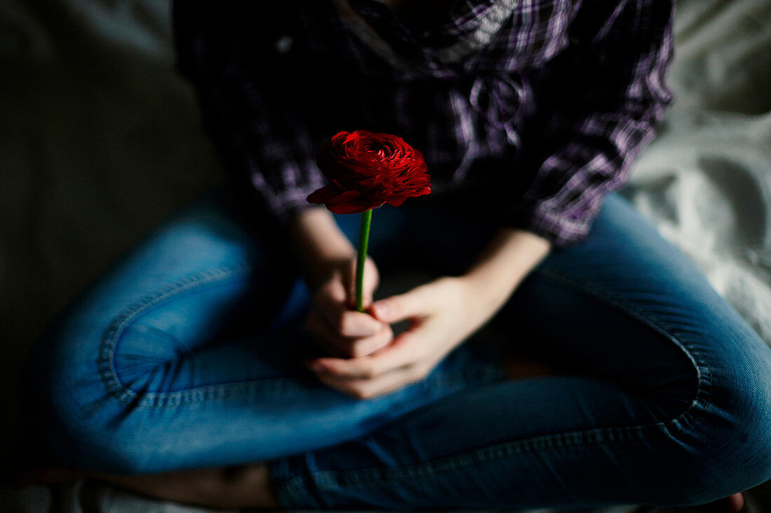 Caucasian teenage girl holding flower