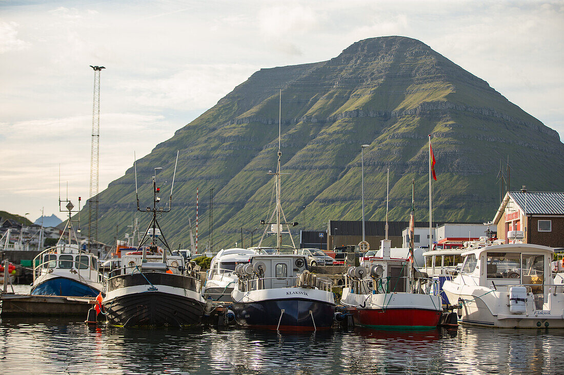 Little fishing village surrounded by green mountains, Faeroe Islands