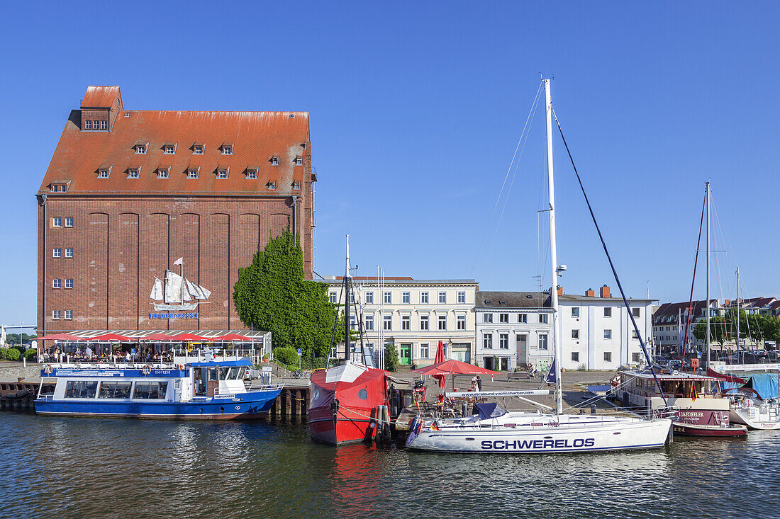 Segelboote im Hafen vor einem alten Speicherhaus in der Hansestadt Stralsund, Ostseeküste, Vorpommern, Mecklenburg-Vorpommern, Norddeutschland, Deutschland, Europa