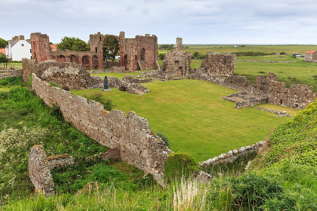 Lindisfarne Priory, early Christian site, and village, elevated view, Holy Island, Northumberland Coast, England, United Kingdom, Europe