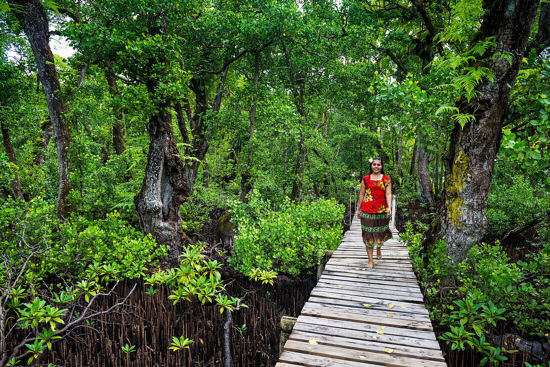 Local girl walking along a long wooden pier, Kosrae, Federated States of Micronesia, South Pacific