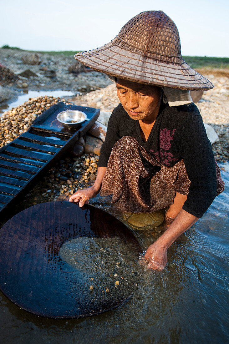 A Burmese woman panning for gold in a small stream near Putao in the north, Kachin State, Myanmar (Burma), Asia