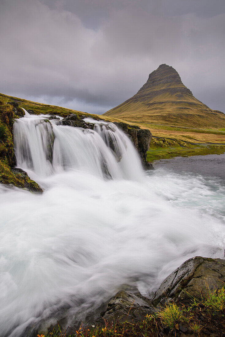 Rushing glacial run-off feeds Kirkjufellfoss on the Snaefellsness Peninsula, Iceland, Polar Regions