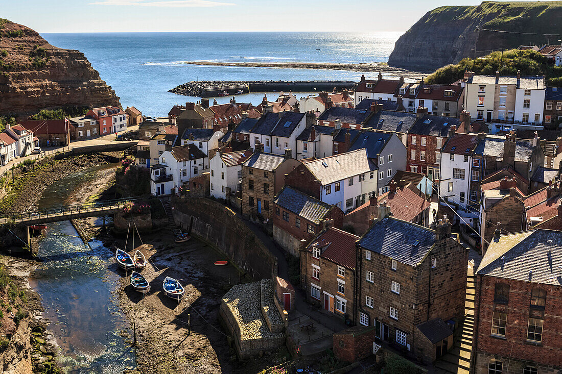 Winding alleys, fishing boats and sea, elevated view of village in summer, Staithes, North Yorkshire Moors National Park, Yorkshire, England, United Kingdom, Europe