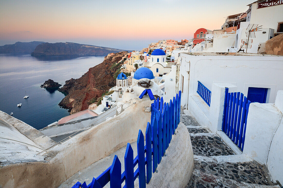 The last light of dusk over the Aegean Sea seen from the typical village of Oia, Santorini, Cyclades, Greek Islands, Greece, Europe