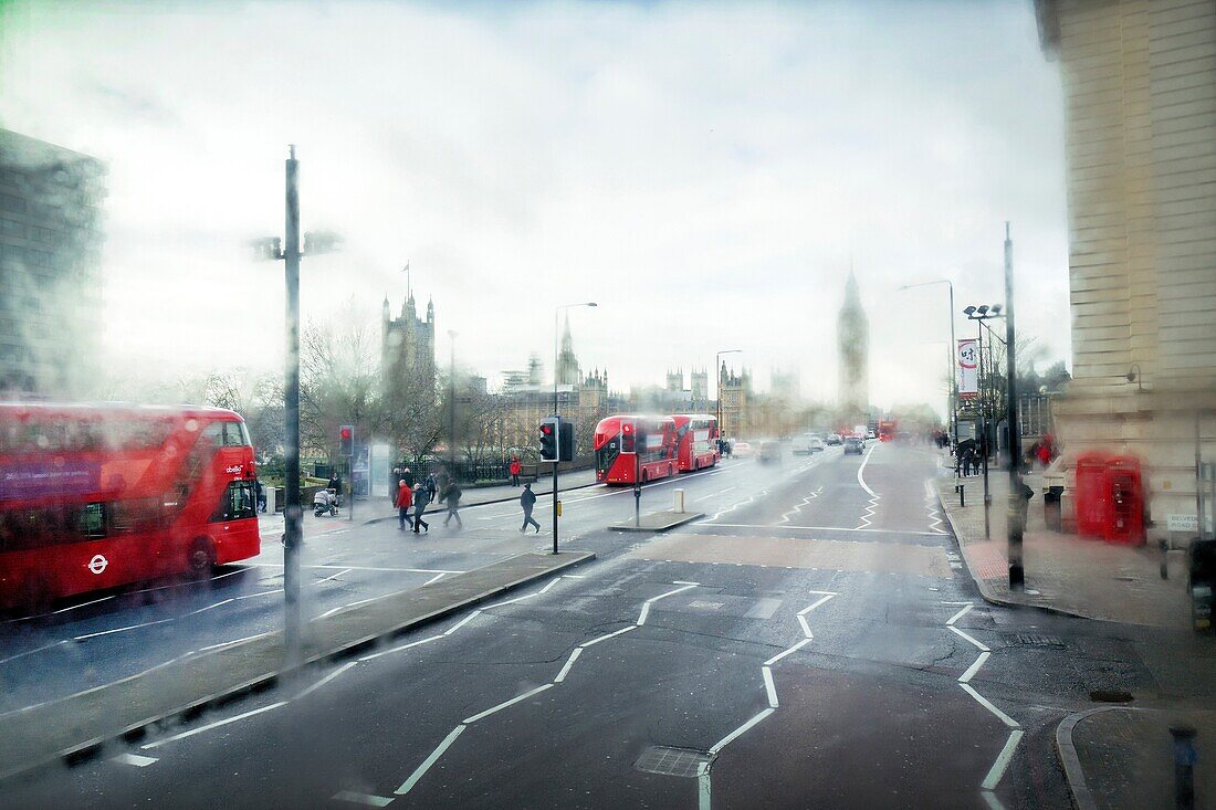 Street scene, view from bus rear window on a rainy day. Westminster, London, England