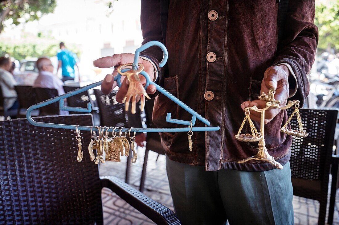 Street seller selling imitation jewelery. Fez, Morocco