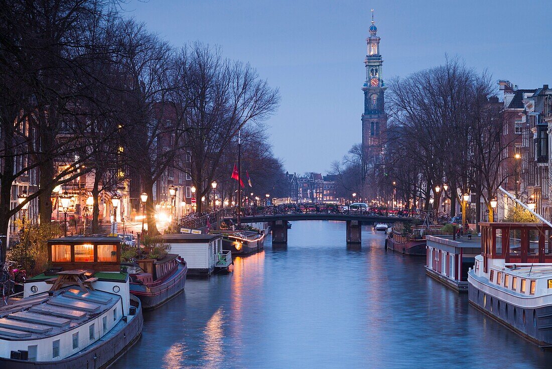 Netherlands, Amsterdam, along Prinsengracht canal, towards Westerkerk church dusk.