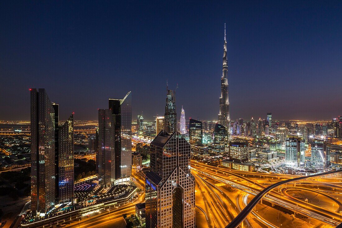 UAE, Dubai, Downtown Dubai, eleavted view over Sheikh Zayed Road and Burj Khalifa Tower, world's tallest building, 2016, dusk.